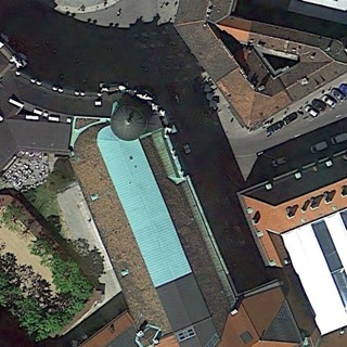 An aerial image of a church with a long green roof, labeled Church in AID. All five models predicted Center or Square.